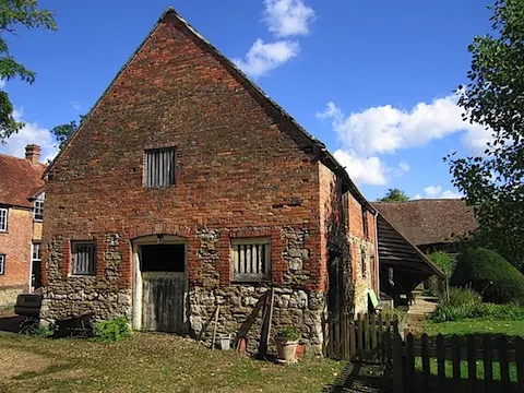 The brick gable end of the barn before conversion