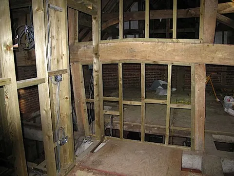 Inside the barn during conversion, with the timber frame being infilled