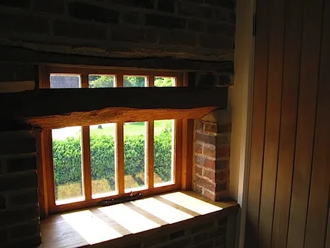 A new oak window and deep sill set into the old brick wall