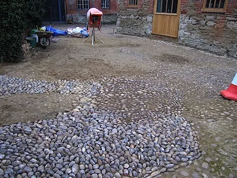 A courtyard newly paved with cobbles