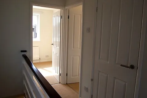 A refurbished landing with white panelled doors