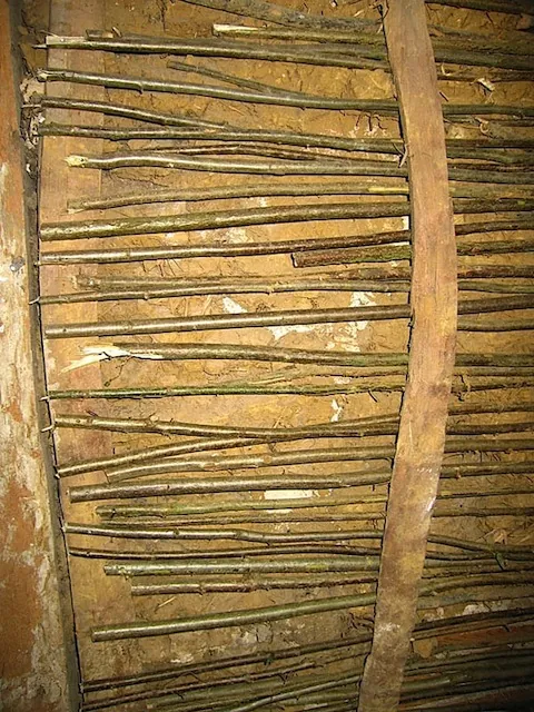 Woven wattle panel set into a timber frame, ready for daub
